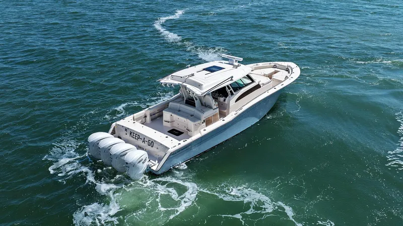  Yacht Photos Pics 2023 Grady-White Canyon 456 boat cruising on open water, rear view.
