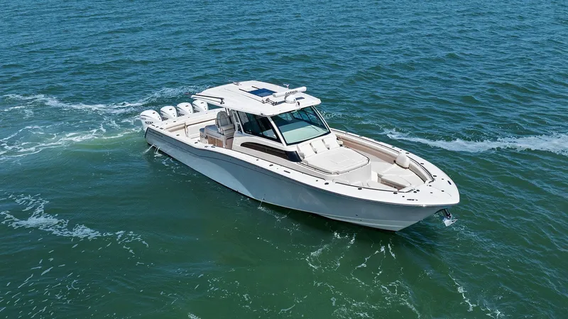  Yacht Photos Pics 2023 Grady-White Canyon 456 boat cruising on open water.