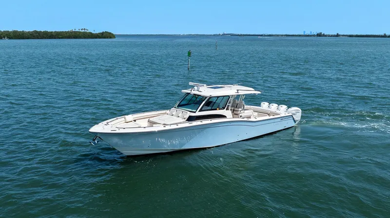  Yacht Photos Pics 2023 Grady-White Canyon 456 boat cruising on open water.