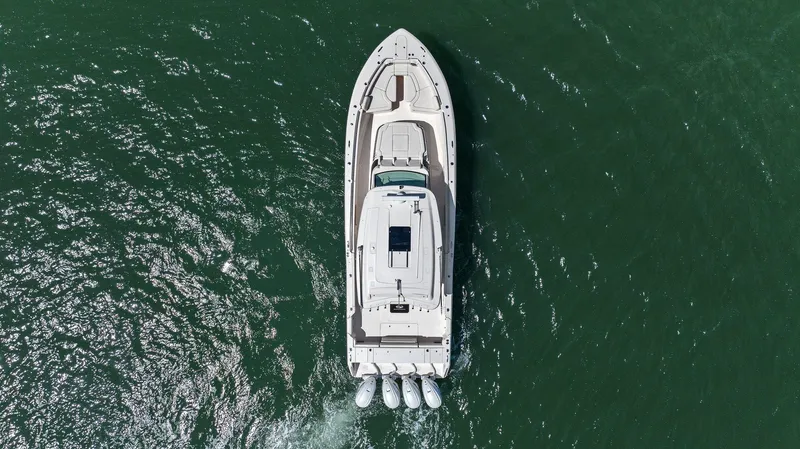  Yacht Photos Pics 2023 Grady-White Canyon 456 boat cruising on open water, aerial view.