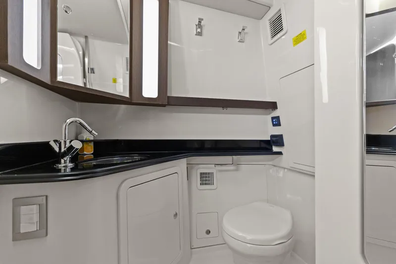  Yacht Photos Pics 2023 Grady-White Canyon 456 boat bathroom with modern fixtures and sleek design.