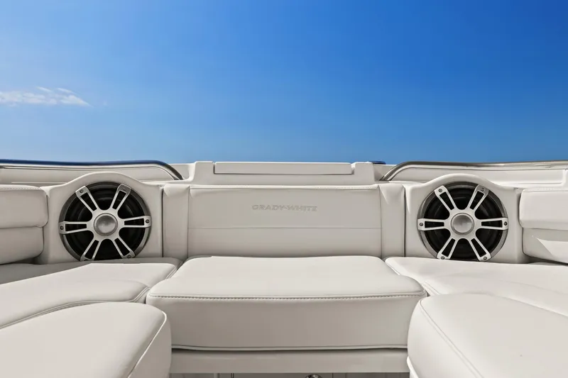  Yacht Photos Pics 2023 Grady-White Canyon 456 boat interior with white seating and speakers under a clear blue sky.