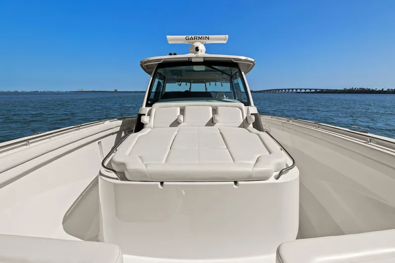  Yacht Photos Pics 2023 Grady-White Canyon 456 boat on water, featuring spacious deck and Garmin equipment.