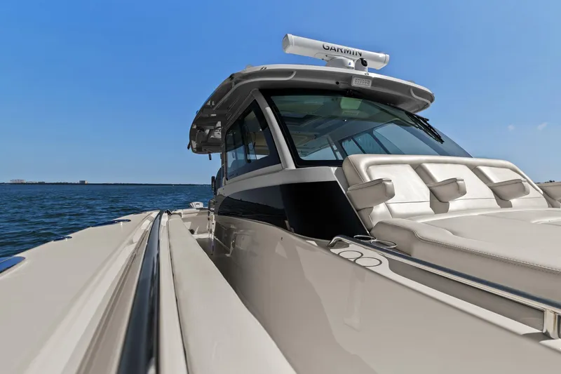  Yacht Photos Pics 2023 Grady-White Canyon 456 boat on open water, showcasing sleek design and luxury features.