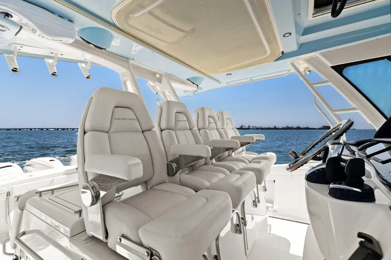  Yacht Photos Pics 2023 Grady-White Canyon 456 boat interior with luxurious seating and helm, overlooking the ocean.