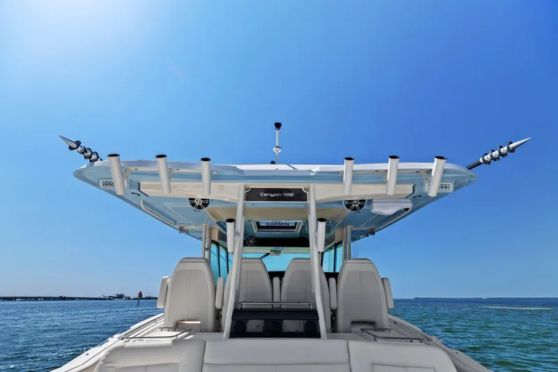  Yacht Photos Pics 2023 Grady-White Canyon 456 boat on open water under clear blue sky.