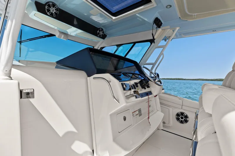  Yacht Photos Pics 2023 Grady-White Canyon 456 boat interior with modern dashboard and ocean view.