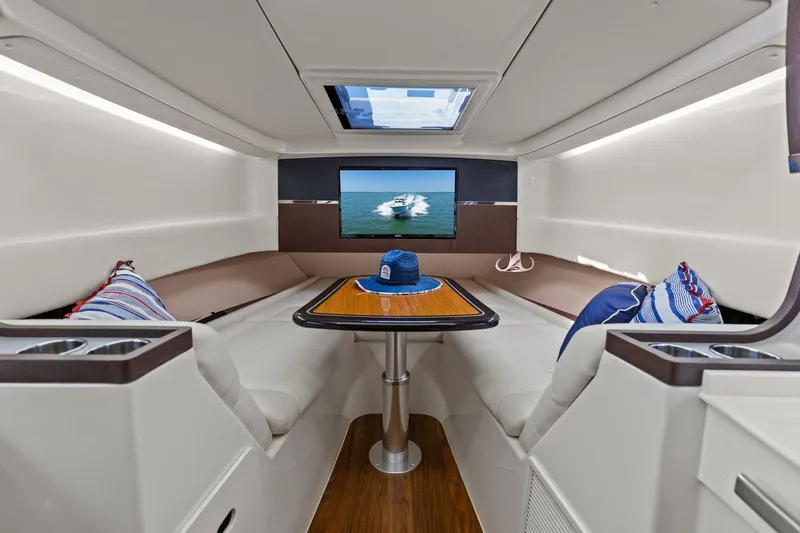  Yacht Photos Pics 2023 Grady-White Canyon 456 cabin interior with seating, table, and skylight.