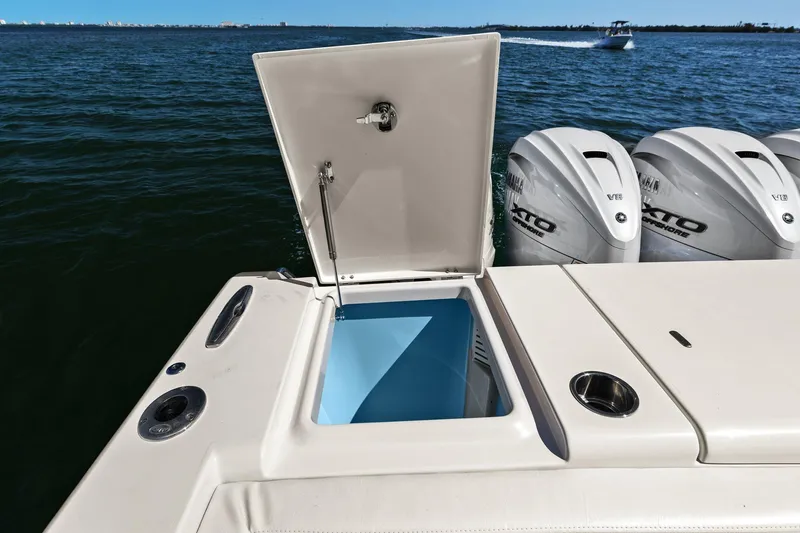  Yacht Photos Pics 2023 Grady-White Canyon 456 boat with open storage compartment and powerful outboard engines.