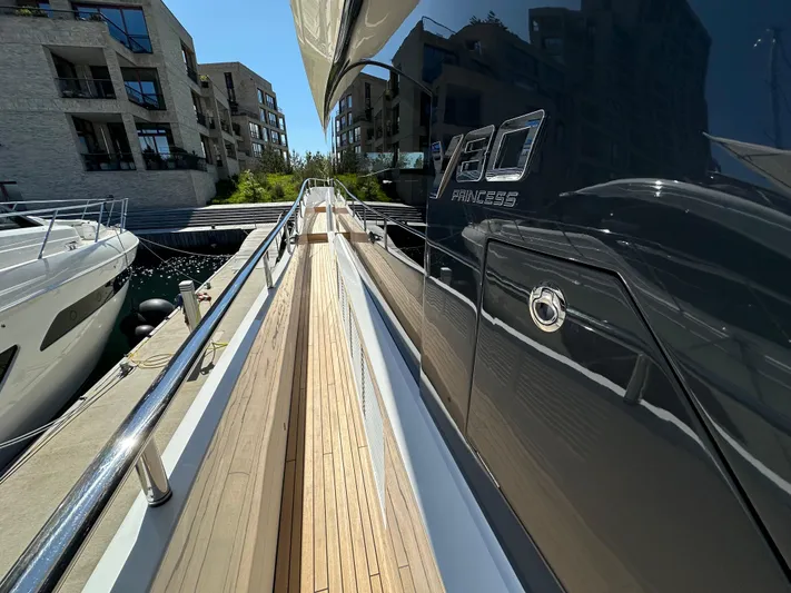  Yacht Photos Pics Luxury yacht Princess Y80, 2025 model, docked at marina with modern buildings.