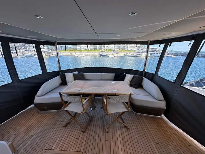  Yacht Photos Pics Luxurious 2025 Princess Y80 yacht interior with elegant seating and scenic marina view.