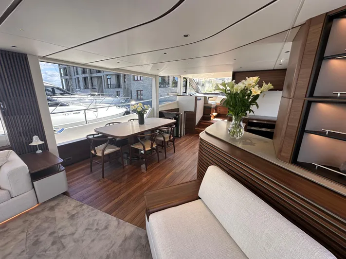  Yacht Photos Pics Luxurious interior of 2025 Princess Y80 yacht with elegant dining area and floral decor.