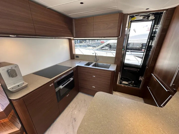  Yacht Photos Pics Modern kitchen in 2025 Princess Y80 yacht with sleek wood cabinetry and appliances.