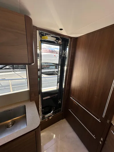  Yacht Photos Pics Luxurious interior of 2025 Princess Y80 yacht with sleek wood finishes and modern design.