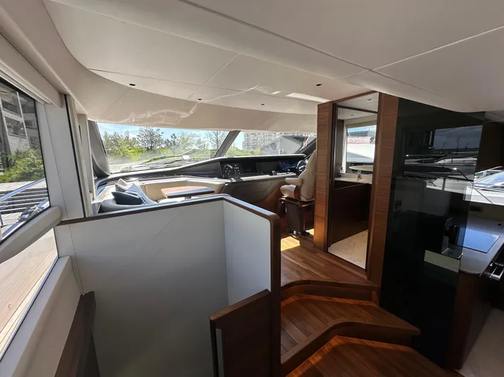  Yacht Photos Pics Luxurious interior of 2025 Princess Y80 yacht with modern helm and wooden accents.