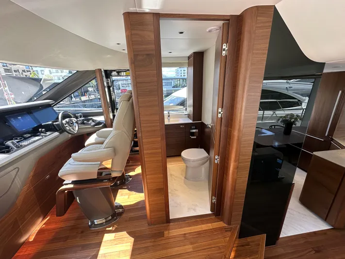  Yacht Photos Pics Luxurious interior of 2025 Princess Y80 yacht with helm, seating, and bathroom.