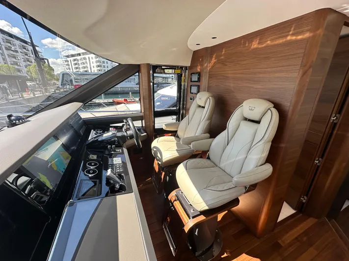  Yacht Photos Pics Luxurious 2025 Princess Y80 yacht interior with modern helm and plush seating.