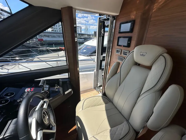  Yacht Photos Pics Luxurious interior of 2025 Princess Y80 yacht with plush seating and modern controls.