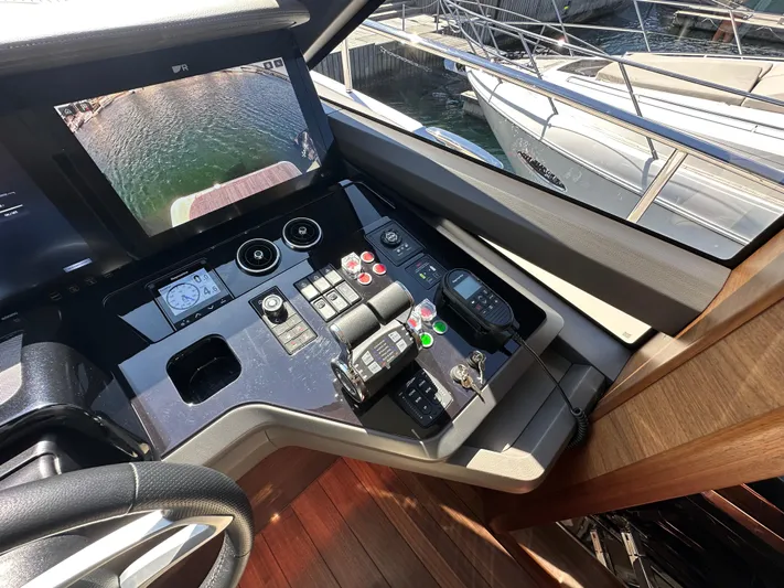  Yacht Photos Pics Control panel of 2025 Princess Y80 yacht with navigation screen and controls.