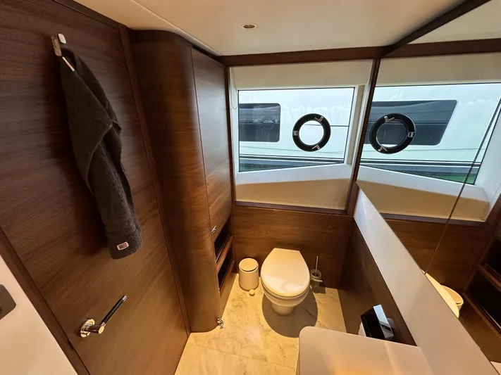  Yacht Photos Pics Luxurious bathroom in 2025 Princess Y80 yacht with modern fixtures and wooden accents.