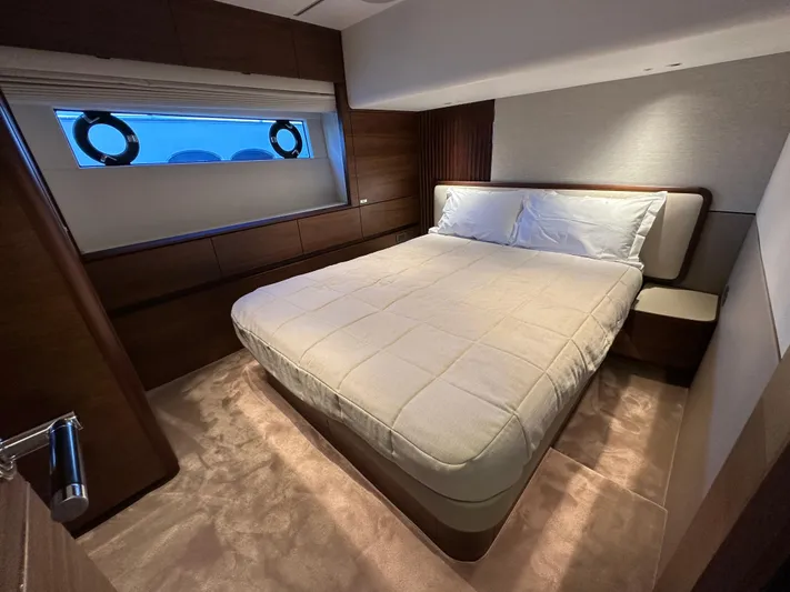  Yacht Photos Pics Luxurious bedroom interior of 2025 Princess Y80 yacht with elegant bedding and wood accents.