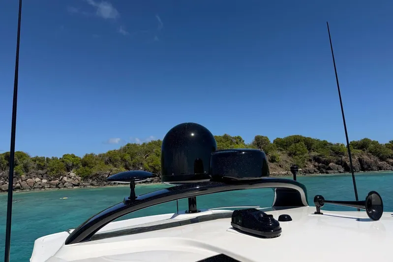  Yacht Photos Pics 2006 Sea Ray 480 Sundancer yacht with radar, cruising near a rocky shoreline.