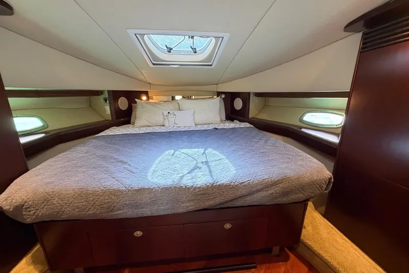  Yacht Photos Pics Luxurious bedroom interior of 2006 Sea Ray 480 Sundancer yacht with skylight and elegant bedding.