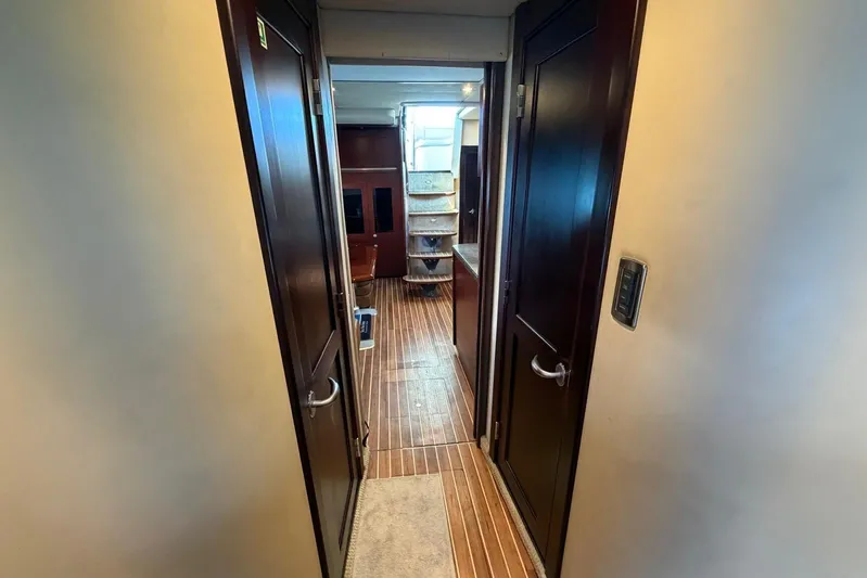  Yacht Photos Pics Interior hallway of 2006 Sea Ray 480 Sundancer yacht with wooden flooring and doors.