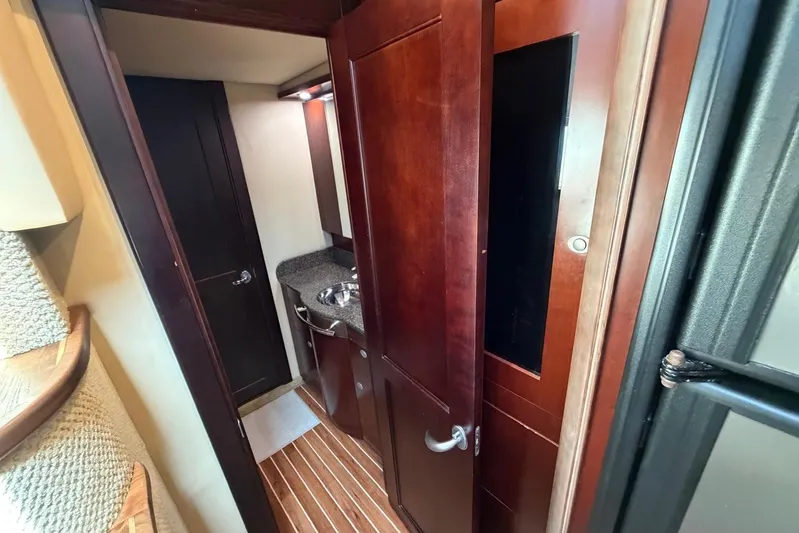  Yacht Photos Pics Interior of 2006 Sea Ray 480 Sundancer yacht with wooden cabinetry and compact sink area.