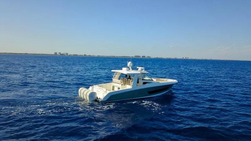  Yacht Photos Pics 2019 Boston Whaler 420 Outrage cruising on open blue sea under clear sky.