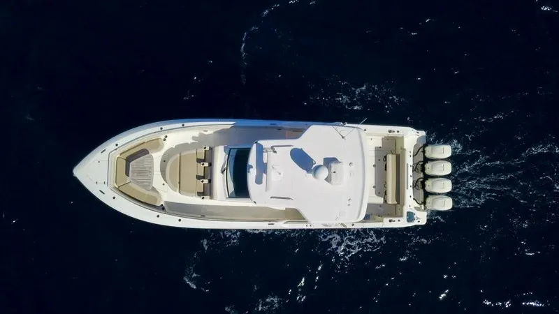  Yacht Photos Pics Aerial view of 2019 Boston Whaler 420 Outrage boat cruising on dark blue water.
