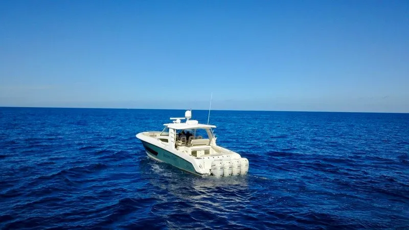  Yacht Photos Pics 2019 Boston Whaler 420 Outrage boat cruising on open blue sea.