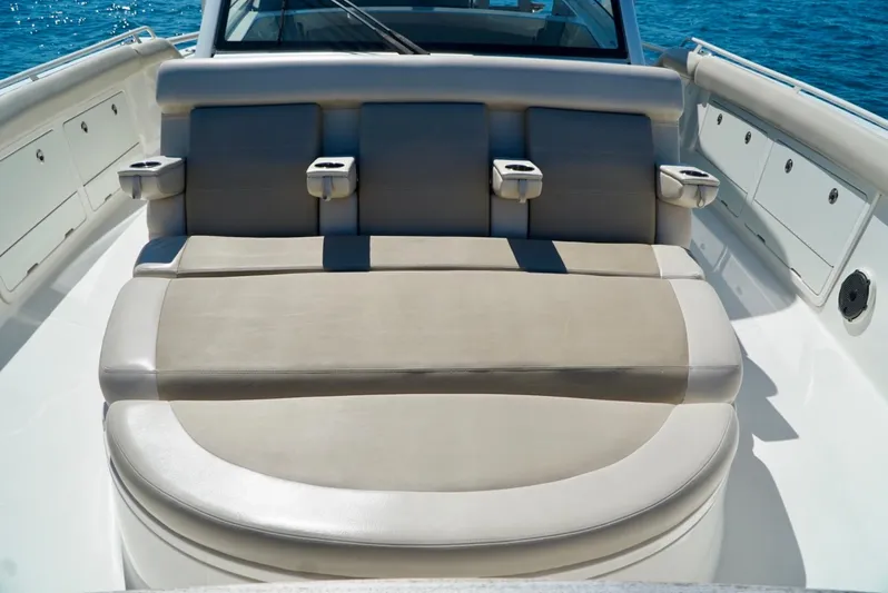  Yacht Photos Pics 2019 Boston Whaler 420 Outrage boat seating area with cup holders, on a sunny day.