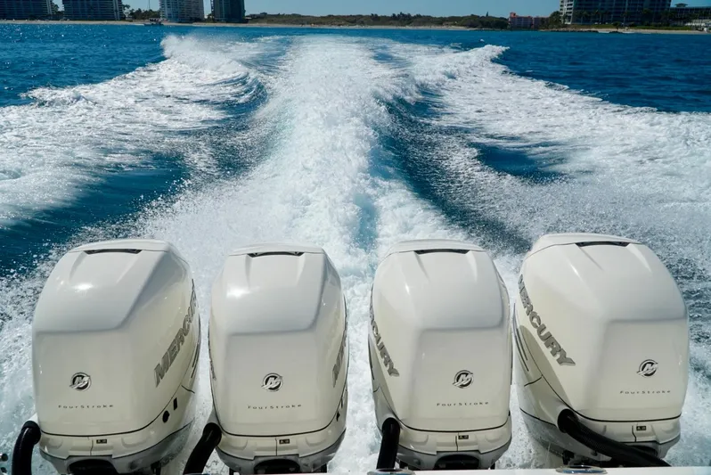 Yacht Photos Pics 2019 Boston Whaler 420 Outrage with four Mercury engines cruising on open water.