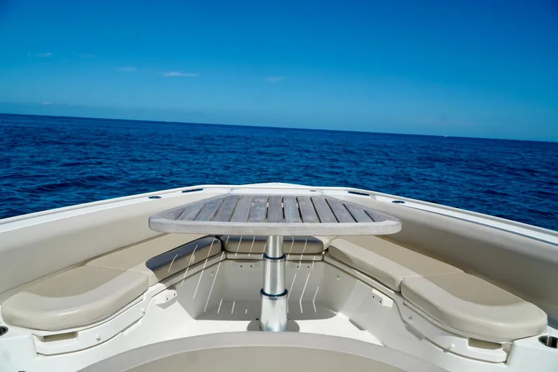  Yacht Photos Pics Boston Whaler 420 Outrage 2019 boat bow with seating and table on open sea.
