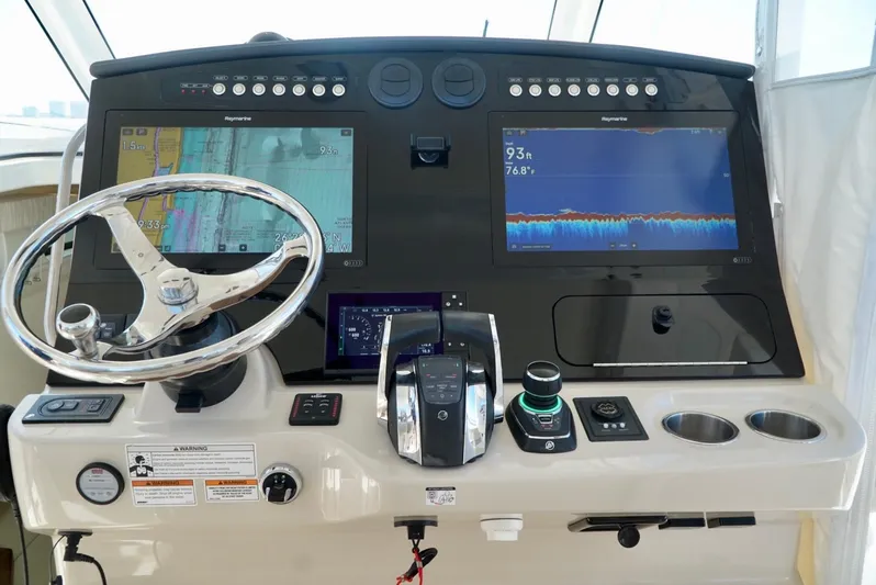  Yacht Photos Pics 2019 Boston Whaler 420 Outrage helm with dual navigation screens and steering wheel.