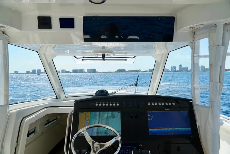  Yacht Photos Pics 2019 Boston Whaler 420 Outrage helm with ocean view and city skyline in the background.