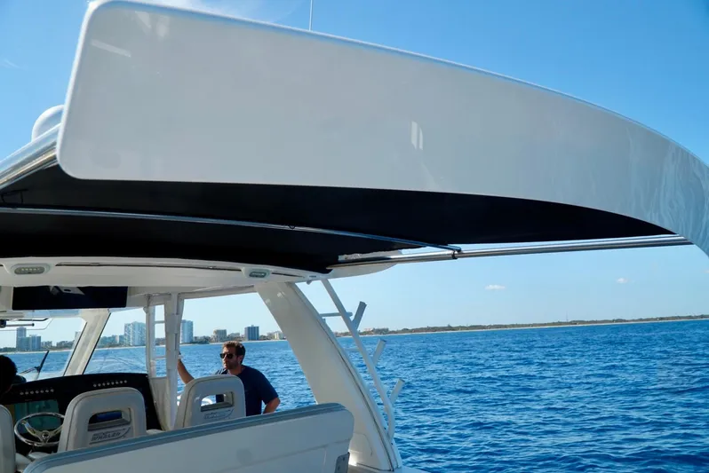  Yacht Photos Pics 2019 Boston Whaler 420 Outrage on open water, featuring sleek design and spacious deck.