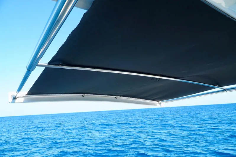  Yacht Photos Pics Boston Whaler 420 Outrage 2019 boat canopy over blue ocean waters.