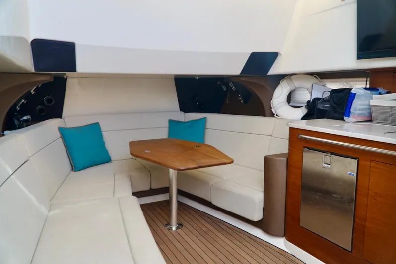  Yacht Photos Pics 2019 Boston Whaler 420 Outrage interior with seating, table, and kitchenette.