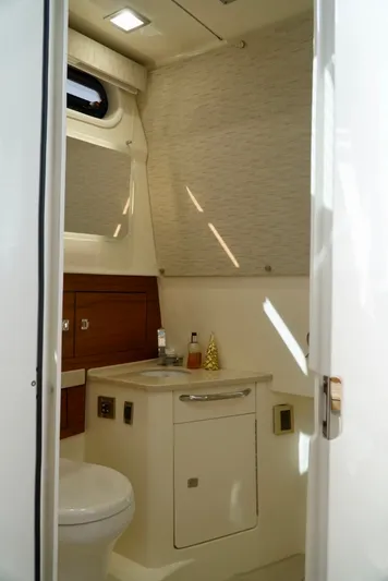  Yacht Photos Pics 2019 Boston Whaler 420 Outrage bathroom interior with modern fixtures and natural lighting.