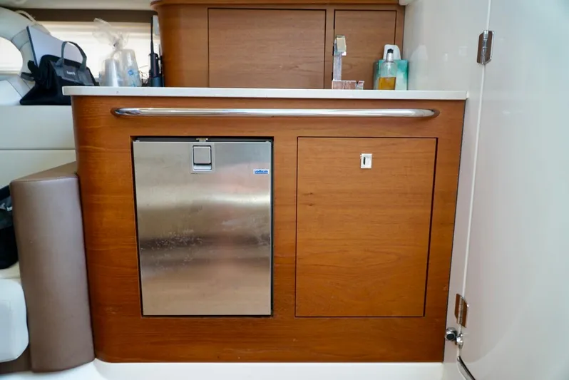  Yacht Photos Pics Interior of 2019 Boston Whaler 420 Outrage, featuring wooden cabinetry and stainless steel appliance.