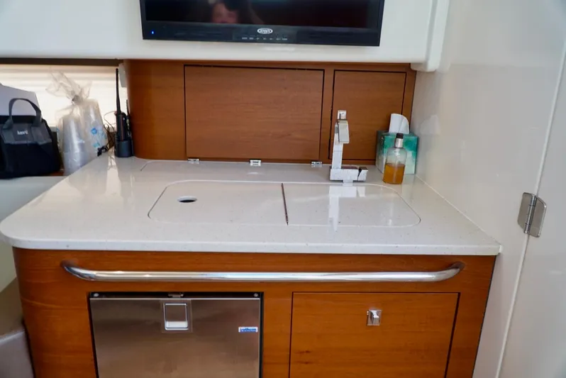  Yacht Photos Pics 2019 Boston Whaler 420 Outrage interior kitchenette with sink and storage.