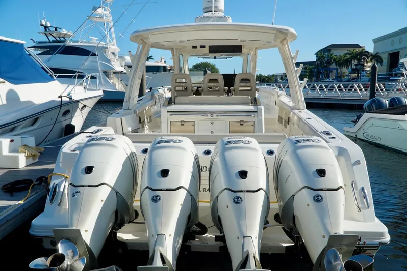  Yacht Photos Pics 2019 Boston Whaler 420 Outrage with four powerful outboard engines docked at marina.
