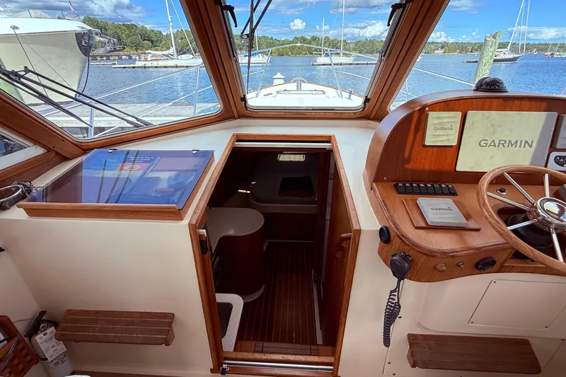 Tova Yacht Photos Pics 2007 Legacy Yachts 32 Sedan interior with Garmin navigation, overlooking marina.