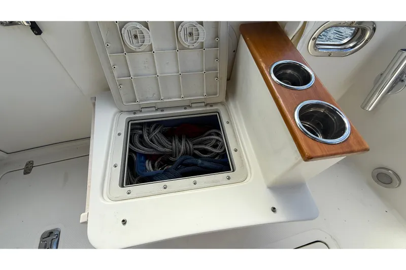 Tova Yacht Photos Pics Open storage compartment on 2007 Legacy Yachts 32 Sedan with ropes and cup holders.