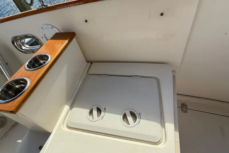 Tova Yacht Photos Pics Cockpit detail of 2007 Legacy Yachts 32 Sedan with cup holders and storage compartment.