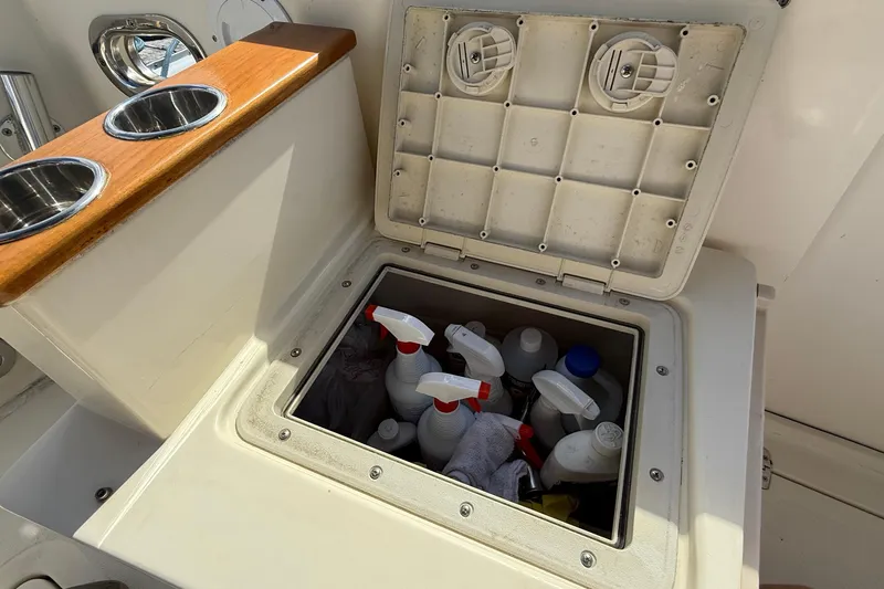 Tova Yacht Photos Pics Storage compartment on 2007 Legacy Yachts 32 Sedan, containing cleaning supplies and spray bottles.