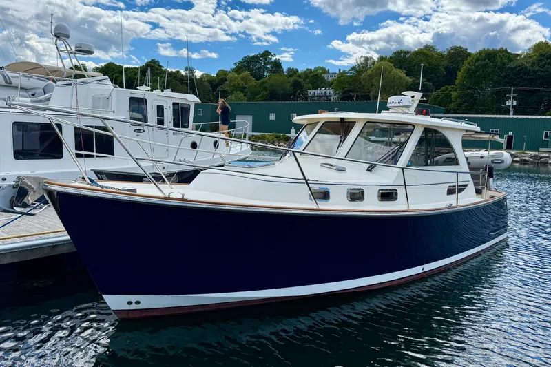 Tova Yacht Photos Pics 2007 Legacy Yachts 32 Sedan docked, featuring sleek design and classic styling.