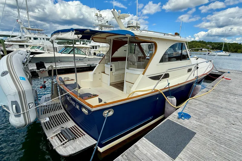 Tova Yacht Photos Pics 2007 Legacy Yachts 32 Sedan docked, featuring a sleek design and spacious deck area.